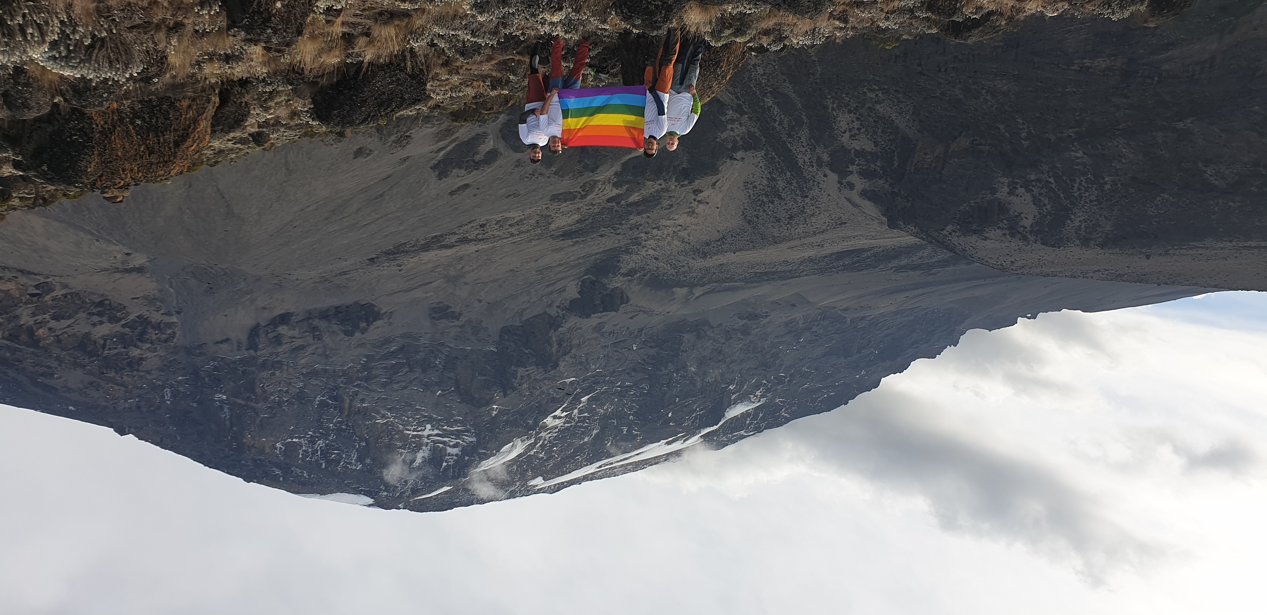 team in front of kili with a rainbow flag © Pink Summits